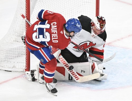 New Jersey Devils goaltender Jacob Markstrom stops  Montreal Canadiens' Cole Caufield (13) during third period NHL hockey action in Montreal, Sunday, April 5, 2026. THE CANADIAN PRESS/Graham Hughes
