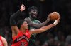 Toronto Raptors forward Collin Murray-Boyles, left, and Boston Celtics center Neemias Queta vie for control of the ball in the first half of an NBA basketball game, Sunday, April 5, 2026, in Boston. (AP Photo/Steven Senne)