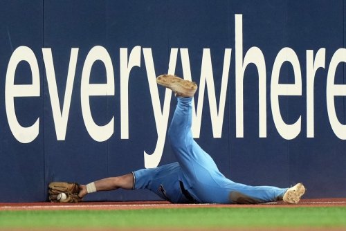 Toronto Blue Jays left fielder Davis Schneider (36) loses the ball as he tries to make a diving catch against the Colorado Rockies during fifth inning MLB baseball action in Toronto on Wednesday, April 1, 2026. THE CANADIAN PRESS/Nathan Denette
