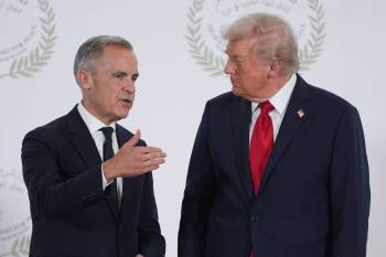 U.S. President Donald Trump (right) greets Prime Minister Mark Carney during a summit on ending the Israel-Hamas war in Sharm El Sheikh, Egypt, in October 2025. (The Associated Press files)