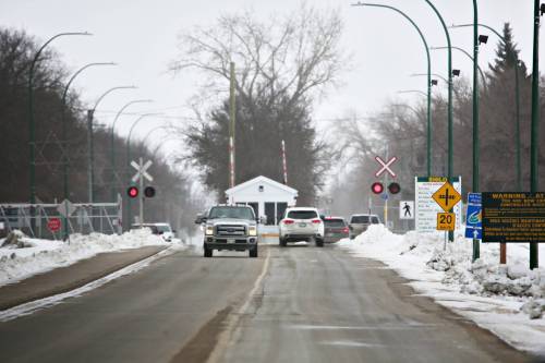 Railway crossing lights flash in front of the north gate of CFB Shilo on Wednesday afternoon. The federal government plans to build about 180 homes at CFB Shilo as part of a national housing expansion for military bases.