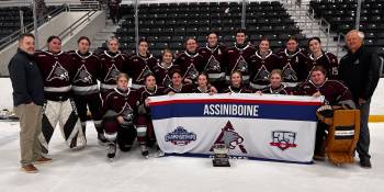 Head coach Charles Tweed, left, goalie Rachel Halldorson and the Assiniboine College Cougars pose after falling 1-0 to the Sault College Cougars on Thursday in the American Collegiate Hockey Association&rsquo;s women&rsquo;s Division 2 national championship final. (Submitted)