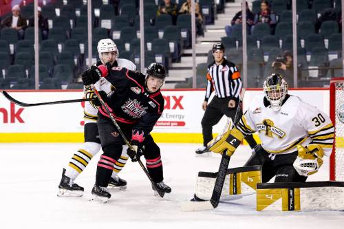 Brandon Wheat Kings goalie Filip Ruzicka (30) monitors the play as Calgary Hitmen forward Harrison Lodewyk (9) and defenceman Gio Pantelas (84) jockey for position during Western Hockey League action at Scotiabank Saddledome on March 11. Ruzicka won both his starts against Calgary this season. (Jenn Pierce/Calgary Hitmen)