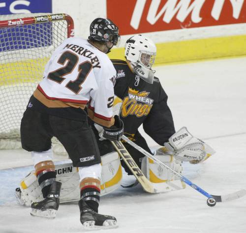 Calgary Hitmen forward Riley Merkley tries to get a shot on Wheat Kings goalie Tyler Plante during Game 4 of the second round of the Western Hockey League playoffs at the Saddledome on April 13, 2005. Calgary won the game 4-2 but Brandon took the series 4-3. (Dean Bicknell/Calgary Herald)
