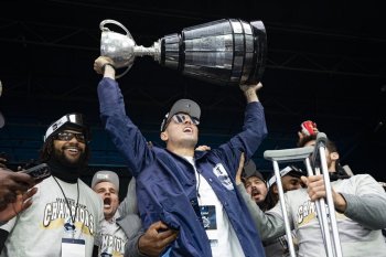 Toronto Argonauts quarterback Chad Kelly lifts the Grey Cup during a Grey Cup championship rally in Toronto on Tuesday, Nov. 19, 2024. The Argonauts defeated the Winnipeg Blue Bombers on Sunday to win the cup. THE CANADIAN PRESS/Arlyn McAdorey