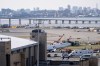 An airport maintenance crew moves the wreckage of an Air Canada Express jet, Wednesday, March 25, 2026, from the runway where it had collided with a Port Authority fire truck Sunday night at LaGuardia Airport, in New York. (AP Photo/Yuki Iwamura)