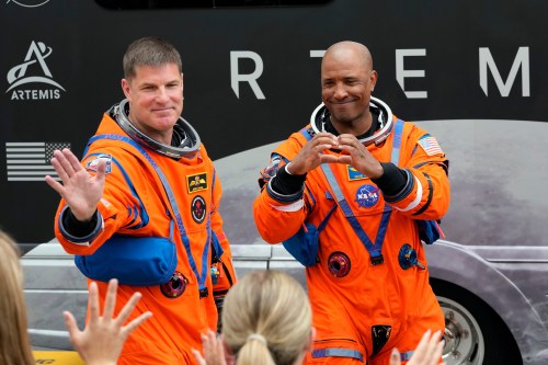 Mission Specialist Jeremy Hansen of Canada and pilot Victor Glover wave to family members as they leave the Operations and Checkout Building for a trip to Launch Pad 39-B and a planned liftoff on NASA's Artemis II moon rocket at the Kennedy Space Center on Wednesday, April 1, 2026, in Cape Canaveral, Fla. (AP Photo/Chris O'Meara)