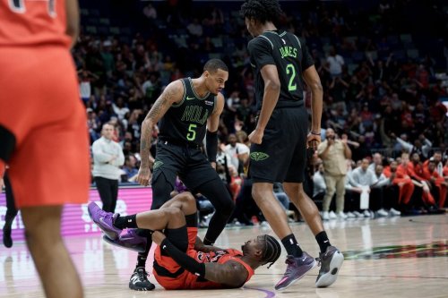 Pelicans guard Dejounte Murray (5) stands over Toronto Raptors guard Jamal Shead (23) next to forward Herbert Jones (2) after Shead fell while trying to defend against the three-point basket of Murray during the second half of an NBA basketball game in New Orleans on March 11, 2026. Murray received a technical foul after standing over him. (AP Photo/Matthew Hinton)