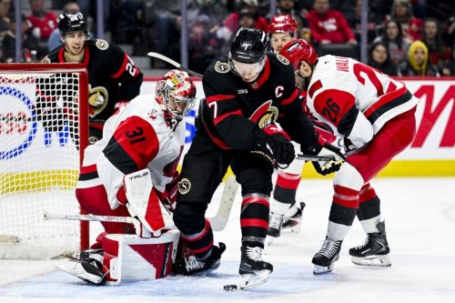 Ottawa Senators' Brady Tkachuk (7) tries to the play the puck off his skate in front of Carolina Hurricanes' goaltender Frederik Andersen (31) during second period NHL hockey action in Ottawa, on Sunday, April 5, 2026. THE CANADIAN PRESS/Spencer Colby