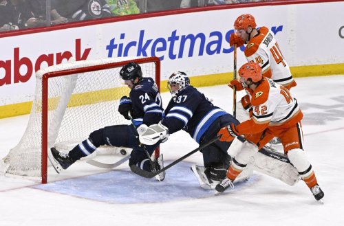 Anaheim Ducks' Tim Washe (42) scores on Winnipeg Jets goaltender Connor Hellebuyck (37) as Haydn Fleury (24) defends during the second period of their NHL hockey game in Winnipeg, Tuesday March 10, 2026. THE CANADIAN PRESS/Fred Greenslade