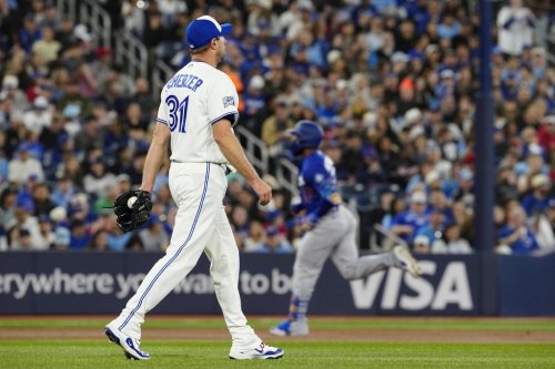 Blue Jays pitcher Max Scherzer (31) walks back to the mound as Los Angeles Dodgers slugger Teoscar Hernández (37) rounds the bases after hitting a two-run homer in a Major League Baseball game in Toronto on April 6, 2026. THE CANADIAN PRESS/Frank Gunn
