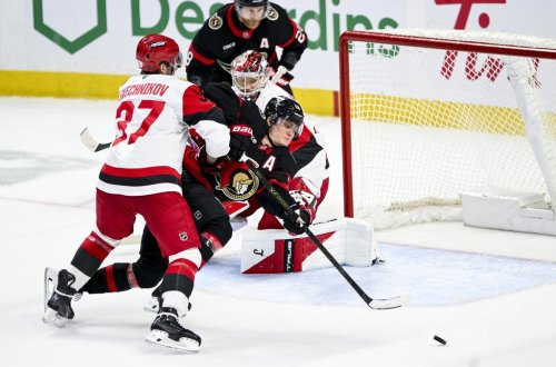 Ottawa Senators' Tim Stützle (18) falls to the ice as he tries to play the puck in front of Carolina Hurricanes goaltender Frederik Andersen (31) during third period NHL hockey action in Ottawa, on Sunday, April 5, 2026. THE CANADIAN PRESS/Spencer Colby