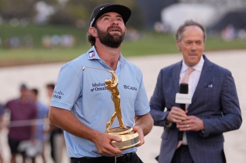 Cameron Young holds the The Players Championship Trophy after winning the final round of The Players Championship golf tournament, Sunday, March 15, 2026, in Ponte Vedra Beach, Fla. (AP Photo/Gerald Herbert)