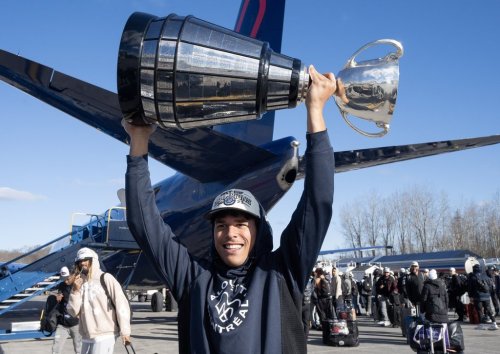 Montreal Alouettes' Tyson Philpot hoists the cup as the team arrives at Mirabel airport after winning the Grey Cup, in Mirabel, Que., Monday, Nov. 20, 2023. THE CANADIAN PRESS/Ryan Remiorz