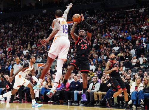 Raptors guard Jamal Shead (23) shoots over Phoenix Suns forward Haywood Highsmith (19) during NBA action in Toronto on March 13, 2026. THE CANADIAN PRESS/Frank Gunn
