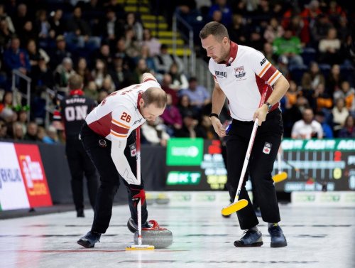 Newfoundland and Labrador-Gushue second Brendan Bottcher, right, and lead Geoff Walker sweep a stone during Draw 5 of the 2026 Montana Brier in St. John's on March 1, 2026. THE CANADIAN PRESS/Paul Daly