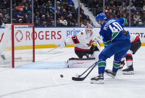 Vancouver Canucks' Elias Pettersson (40) fails to get his stick on the puck as Ottawa Senators goalie James Reimer (47) watches during the third period of an NHL hockey game, in Vancouver, on Monday, March 9, 2026. THE CANADIAN PRESS/Darryl Dyck