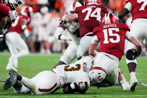 Indiana quarterback Fernando Mendoza is sacked by Miami defensive lineman Akheem Mesidor during the second half of the College Football Playoff national championship game, Monday, Jan. 19, 2026, in Miami Gardens, Fla. (AP Photo/Marta Lavandier)
