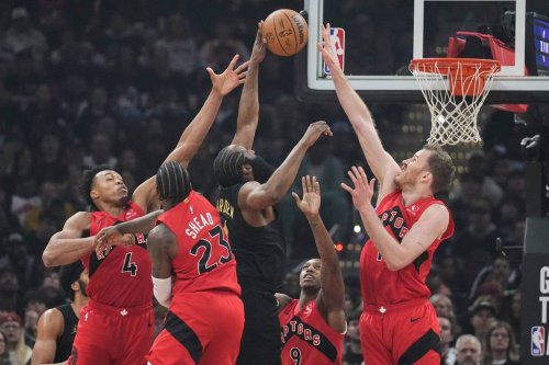 Cleveland Cavaliers' James Harden, centre, shoots between Toronto Raptors' Scottie Barnes (4), Jamal Shead (23) , RJ Barrett (9) and Jakob Poeltl, right, in the first half in Game 7 of a first-round NBA playoff series in Cleveland, Sunday, May 3, 2026. (AP Photo/Sue Ogrocki)