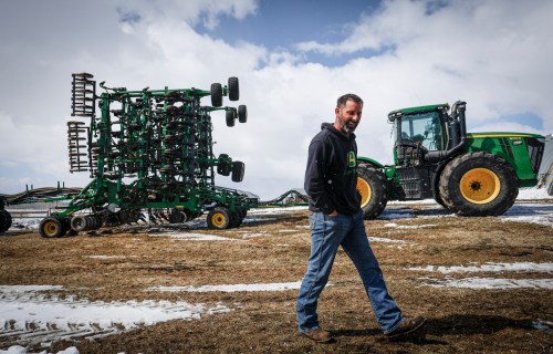 Farmer Bruce Bird walks past his seeding rig on his farm that has been in the family for over 100 years near Cremona, Alta., Friday, April 17, 2026.THE CANADIAN PRESS/Jeff McIntosh