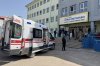 Turkish security forces and emergency staff stand at the courtyard of a high school where an assailant opened fire, in Siverek, south east Turkey, Tuesday, April 14, 2026, (Mevlut Bayraktar/IHA via AP)