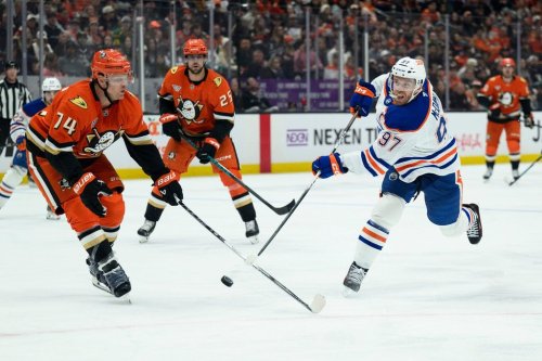 Edmonton Oilers centre Connor McDavid, right, shoots as Anaheim Ducks defenceman John Carlson, left, defends during the second period of Game 4 in the first round of an NHL hockey Stanley Cup playoff series Sunday, April 26, 2026, in Anaheim, Calif. (AP Photo/Kyusung Gong)
