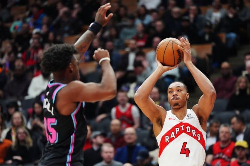 Toronto Raptors' Scottie Barnes (4) shoots over Miami Heat's Davion Mitchell (45) during first half NBA basketball action in Toronto on Tuesday, April 7, 2026. THE CANADIAN PRESS/Frank Gunn