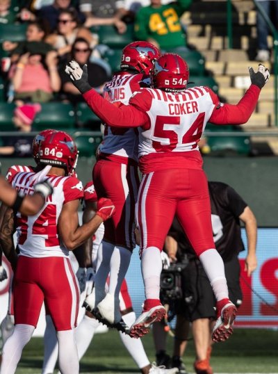 Calgary Stampeders' Joshua Coker (54) and William Langlais (23) celebrate a touchdown against the Edmonton Elks during first half CFL action in Edmonton on Saturday, September 9, 2023. THE CANADIAN PRESS/Jason Franson
