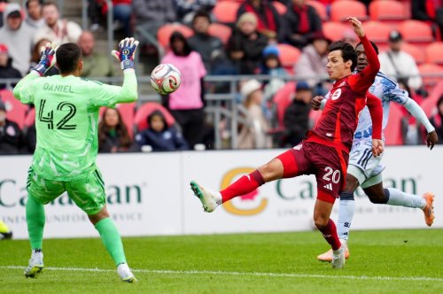 Toronto FC forward Daniel Salloi (20) chips the ball over San Jose Earthquakes goalkeeper Daniel de Sousa Britto (42) during second half MLS soccer in Toronto on Saturday, May 2, 2026. THE CANADIAN PRESS/Frank Gunn