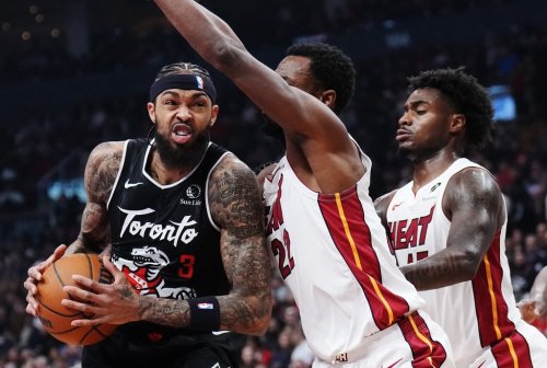 Toronto Raptors' Brandon Ingram (3) drives as Miami Heat's Andrew Wiggins (22) defends during first half NBA basketball action in Toronto on Thursday, April 9, 2026. THE CANADIAN PRESS/Nathan Denette