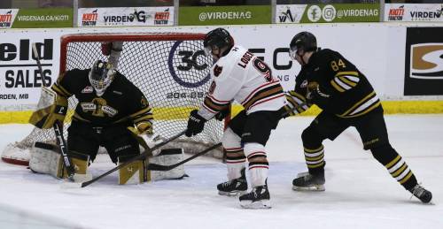 Brandon Wheat Kings goalie Filip Ruzicka (30) makes a stick save as Calgary Hitmen forward Harrison Lodewyk (9) looks for the rebound and Gio Pantelas (84) defends during Game 3 of their Western Hockey League quarterfinal series at Virden's Tundra Oil and Gas Place on Tuesday. Brandon is down 3-0 in the best-of-seven series and looking for a miracle comeback. (Perry Bergson/The Brandon Sun) April 2, 2026