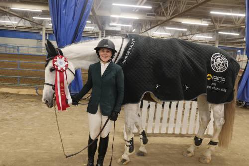 Royal Manitoba Winter Fair Grand Prix title winner Femke Courchaine stands with her horse, Lemonade, shortly after the Memorial Grand Prix in the Assiniboine Credit Union Place main arena on Saturday evening. (Abiola Odutola/The Brandon Sun)
