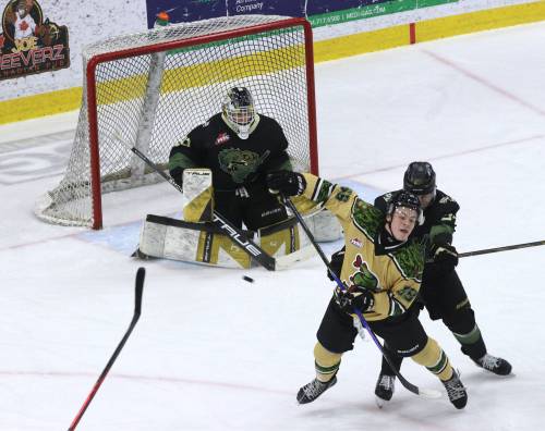 Brandon Wheat Kings defenceman Max Lavoie (27) sends Swift Current Broncos forward Jaxen Gauthier (39) flying with a crosscheck to the back as goalie Filip Ruzicka (30) deals with the puck during Western Hockey League action at Assiniboine Credit Union Place on March 7. Lavoie made the front of the Brandon net an unpleasant place to be for opposing forwards. (Perry Bergson/The Brandon Sun)
                                March 7, 2026