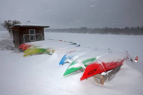 Kayaks sit covered in snow at the Clear Lake Marina at the townsite of Wasagaming in Riding Mountain National Park during flurries on Wednesday. Parks Canada announced Wednesday that motorized watercraft would be allowed on Clear Lake in 2026, subject to new rules. (Tim Smith/The Brandon Sun)