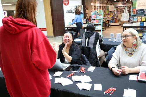 Field operation supervisor Joahna Zilinsky and crew leader Tara-Love Hilsher with Statistics Canada speak with a visitor at the 22nd annual Interprovincial Association of Native Employment Indigenous Career Fair at the Shoppers Mall in Brandon on Wednesday. (Tim Smith/The Brandon Sun)