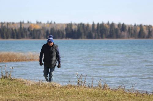 Keeseekoowenin Ojibway First Nation chief Dwayne Sonny Blackbird in 2025 walks the shoreline at Clear Lake on land that belongs to his First Nation. (Connor McDowell/The Brandon Sun files)