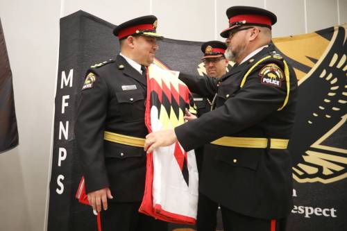 New Manitoba First Nations Police Service Chief Jason Colon (left) is presented with the first of two star blankets during his swearing-in ceremony at the Waywayseecappo Convention Centre on Highway 10 on Tuesday morning. (Photos by Tim Smith/The Brandon Sun)