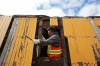 Chris Maynard, a trades worker with the City of Brandon, works on removing rotted wood from the CP Rail caboose.