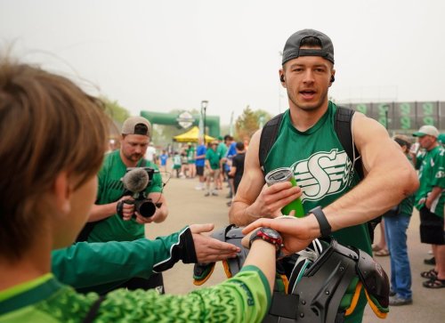 Saskatchewan Roughriders receiver Mitch Picton interacts with fans before a spring training scrimmage in Saskatoon, Sask., on Saturday, May 20, 2023. THE CANADIAN PRESS/Heywood Yu