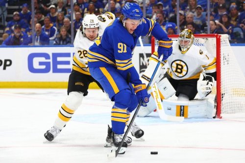 Buffalo Sabres right wing Josh Doan (91) carries the puck past Boston Bruins defenceman Andrew Peeke (26) during the first period in Game 1 of a first-round NHL hockey Stanley Cup playoff series Sunday, April 19, 2026, in Buffalo, N.Y. (AP Photo/Jeffrey T. Barnes)