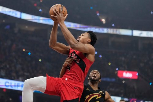 Toronto Raptors forward Scottie Barnes (4) is fouled by Cleveland Cavaliers guard Donovan Mitchell, right, in the first half in Game 7 of a first-round NBA basketball playoffs series in Cleveland, Sunday, May 3, 2026. (AP Photo/Sue Ogrocki)