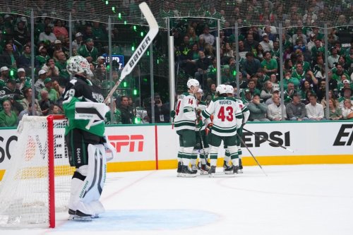 Dallas Stars goaltender Jake Oettinger, left, looks on as Minnesota Wild players celebrate a second period power play goal by left wing Matt Boldy, back right, in Game 5 of a first-round NHL Stanley Cup playoffs hockey series, Tuesday, April 28, 2026, in Dallas. (AP Photo/Julio Cortez)