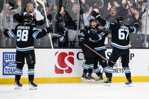 Utah Mammoth right wing Clayton Keller, center left, reacts to scoring a goal with teammates Utah Mammoth defenseman MacKenzie Weegar, center right, Utah Mammoth left wing Lawson Crouse, right, and Utah Mammoth defenseman Mikhail Sergachev, left, during the third period of Game 4 of a first-round NHL hockey Stanley Cup playoff series, Monday, April 27, 2026, in Salt Lake City. (AP Photo/Tyler Tate)