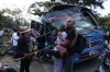 Relatives of victims embrace in front of a bus hit by an explosive device on the Pan-American Highway in Cajibio, Colombia, Saturday, April 25, 2026, after an attack blamed by authorities on dissident groups of the former FARC rebels killed at least a dozen people. (AP Photo/Santiago Saldarriaga)