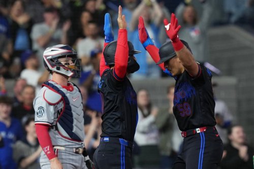 Toronto Blue Jays' Brandon Valenzuela (right) celebrates his two-run home run with Andres Gimenez (0) in front of Minnesota Twins catcher Ryan Jeffers (27) during fourth inning MLB baseball action in Toronto on Friday, April 10, 2026. THE CANADIAN PRESS/Chris Young