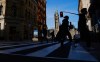 The flag flies on the Peace Tower of Parliament Hill as pedestrians make their way along Sparks Street Mall in Ottawa on Tuesday, Nov. 9, 2021.THE CANADIAN PRESS/Sean Kilpatrick