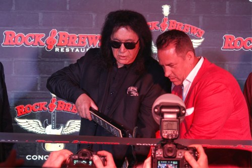 In this image taken from video, KISS frontman Gene Simmons appears with co-franchise owner Danny Yezbick at a ribbon cutting ceremony for Rock & Brews restaurant in Royal Oak, Mich., on Thursday, April 9, 2026. (AP Photo/Mike Householder)