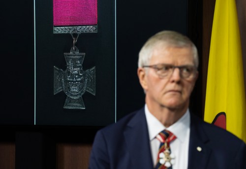 A Victoria Cross is seen behind former chief of the defence staff Rick Hillier during a news conference on Parliament Hill in Ottawa on Wednesday, April 15, 2026. THE CANADIAN PRESS/Adrian Wyld