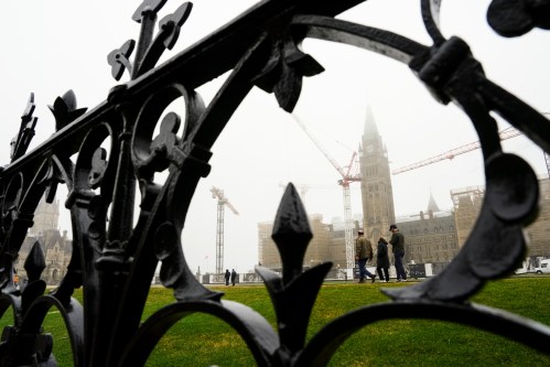People make their way on Parliament Hill as a heavy fog hangs over downtown Ottawa on Thursday, April 16, 2026. THE CANADIAN PRESS/Sean Kilpatrick