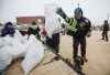 Manitoba Premier Wab Kinew loads sandbags onto a trailer at Peguis First Nation, Man., on Thursday, April 16, 2026. Peguis community sandbagged to protect against potential flooding from the Fisher River.  THE CANADIAN PRESS/John Woods